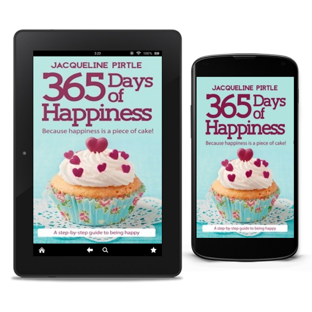 The image shows two electronic devices displaying the cover of the eBook "365 Days of Happiness" by bestselling author Jacqueline Pirtle. The cover features a bright, cheerful design with a cupcake and the title text.