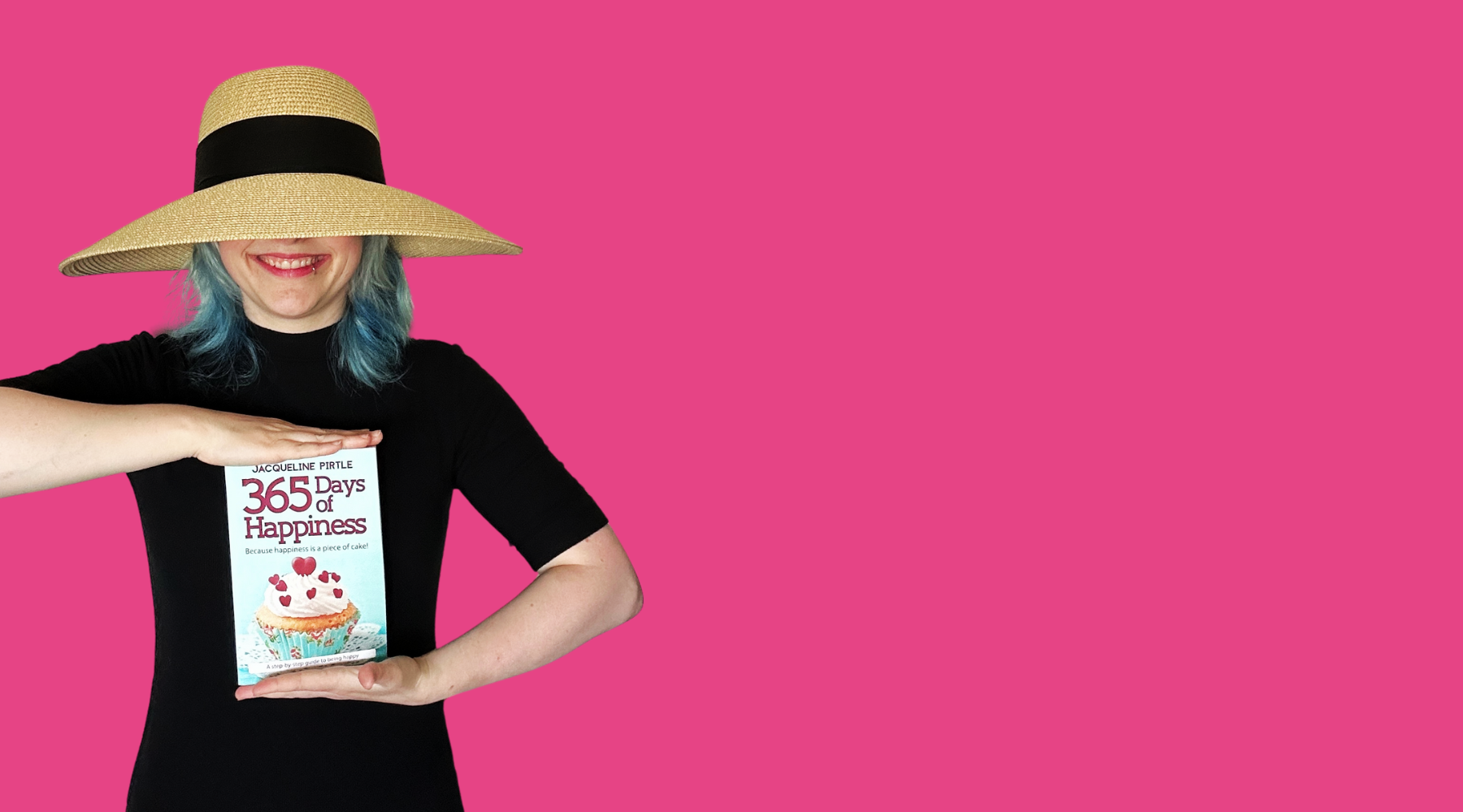 Woman wearing a wide-brimmed hat holding the book 365 Days of Happiness by Jacqueline Pirtle against a pink background