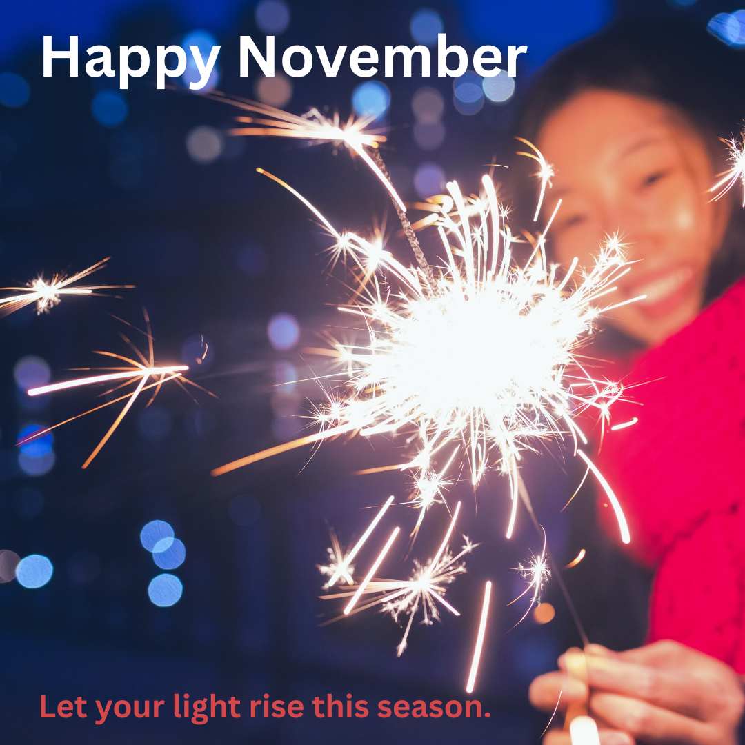 A smiling woman holds a bright sparkler at night, symbolizing joy, warmth, and personal energy rising during the holiday season. Text overlay reads “Happy November – Let your light rise this season.