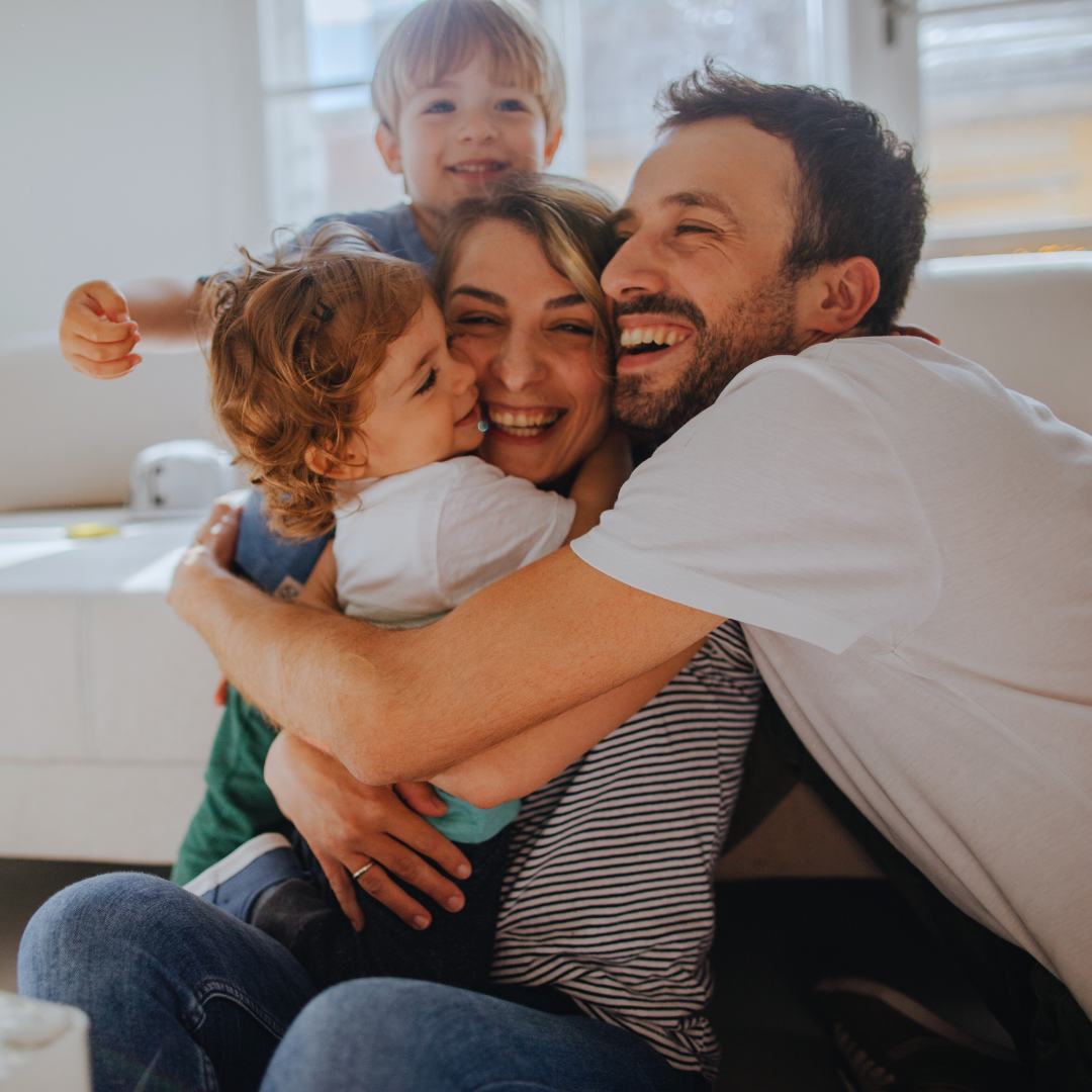 Family, parents and children hugging and laughing