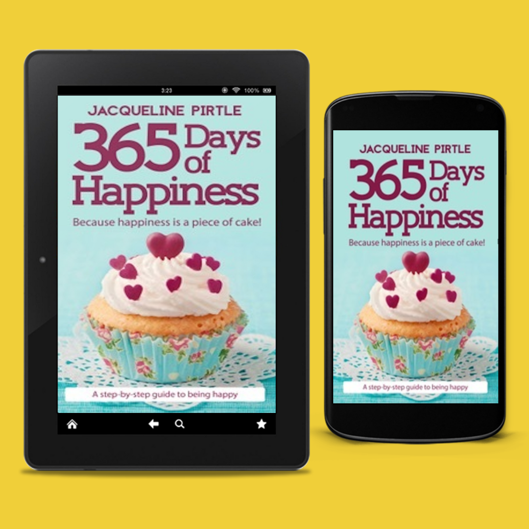 The image shows two electronic devices displaying the cover of the eBook "365 Days of Happiness" by bestselling author Jacqueline Pirtle. The cover features a bright, cheerful design with a cupcake and the title text.